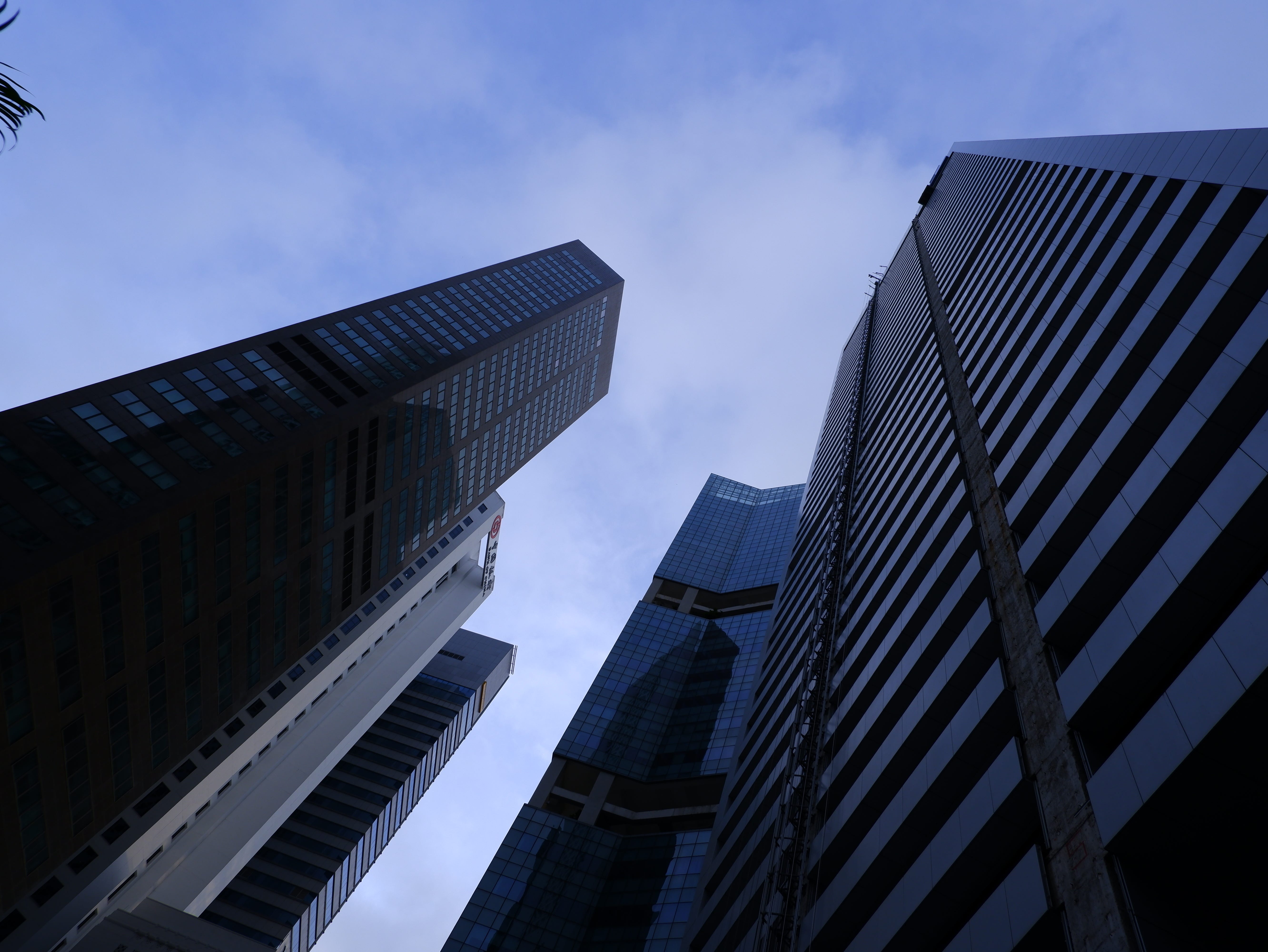 Office buildings reach for the cloudy morning sky outside Raffles Place MRT station