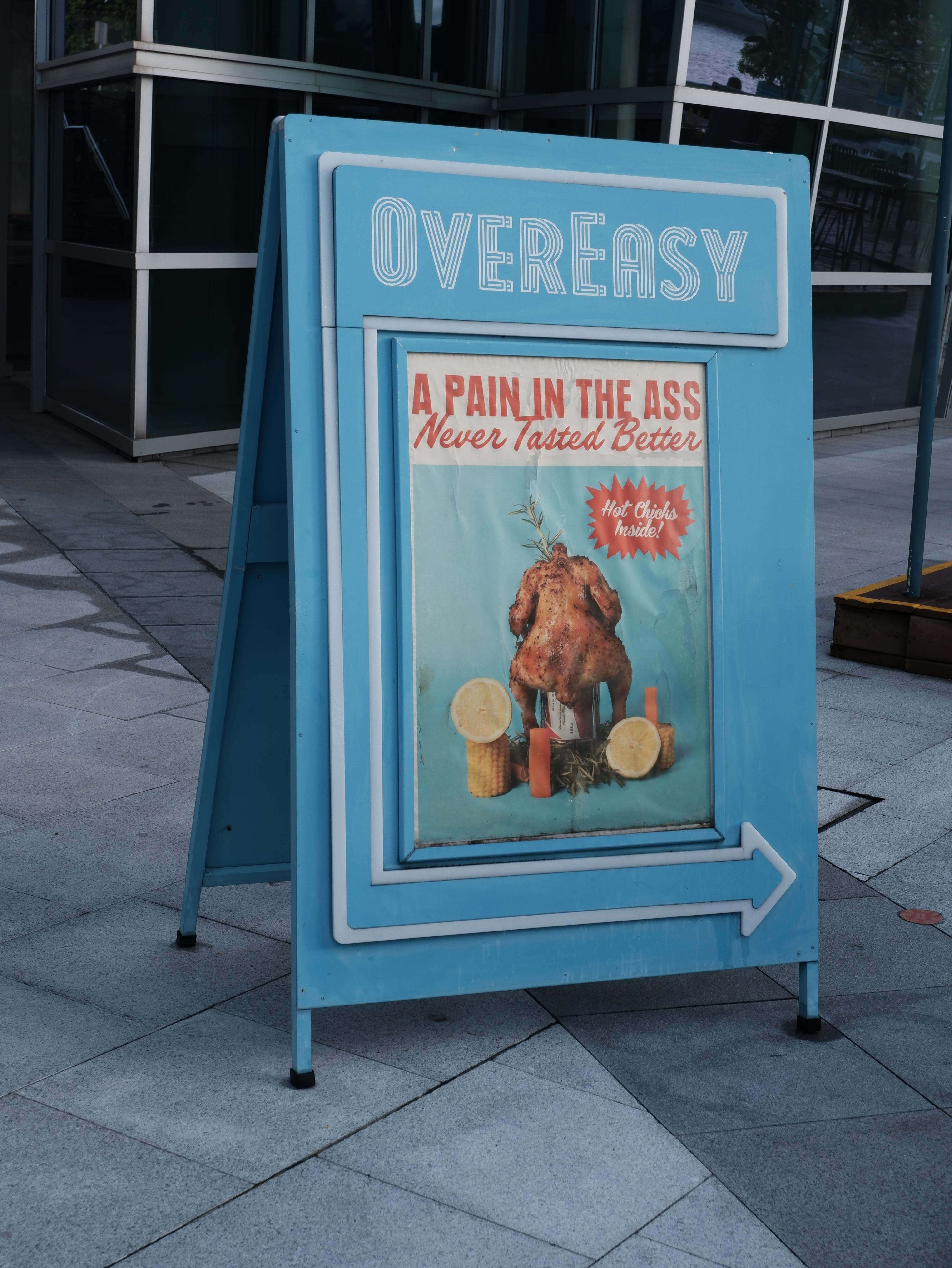 A restaurant signboard tries to lure patrons in with risqué wording. The restaurant was closed at this time though.