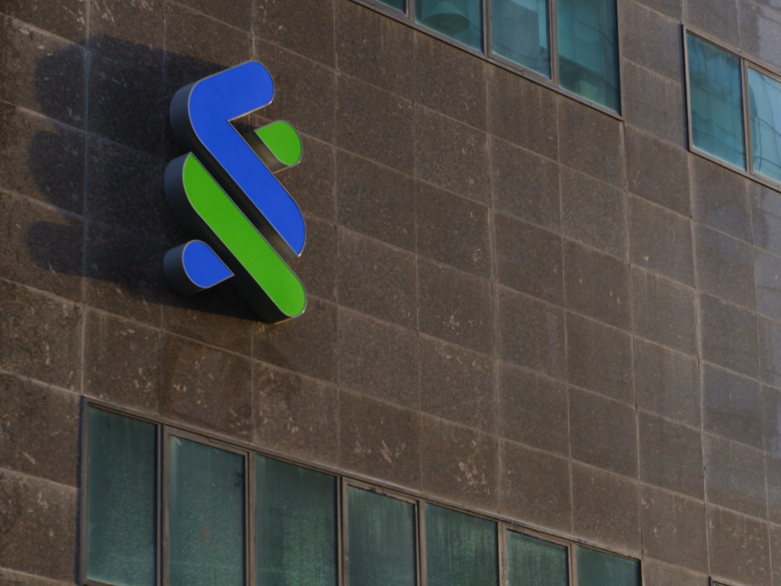 Office buildings reflect the soft light from the rising sun.